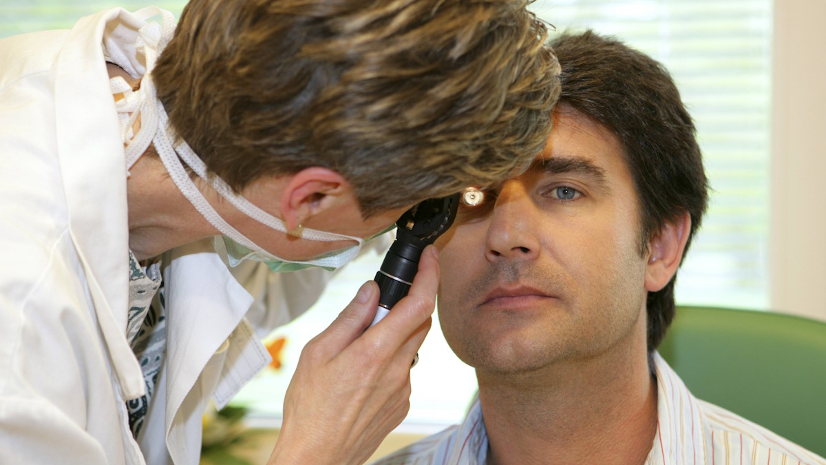 Доктор проверяет глаза у пациента